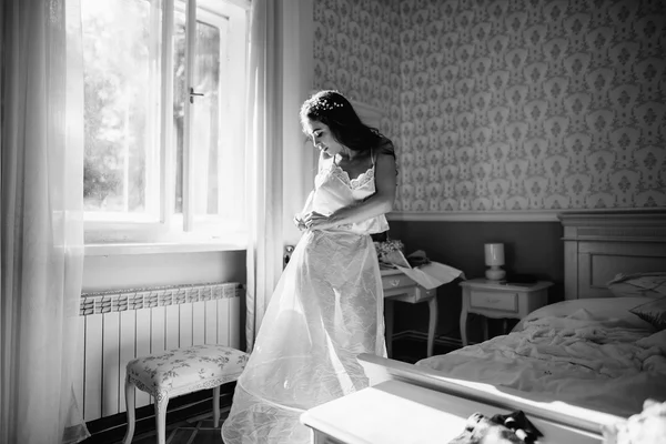 Bride in lingerie, wearing a wedding dress — Stock Photo, Image