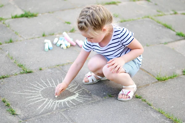 Bedårande liten flicka ritar utanför med krita — Stockfoto