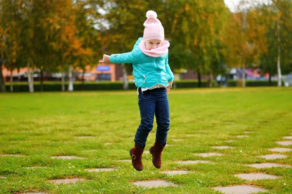 Menina pulando no parque de outono — Fotografia de Stock