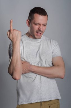 Hafif rahat T-shirt gri bir bac üzerine bir yakışıklı, kaslı adam