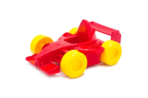 Plastikowe wyścigi czerwony zabawka Zabawka z żółte koła — Zdjęcie stockowe