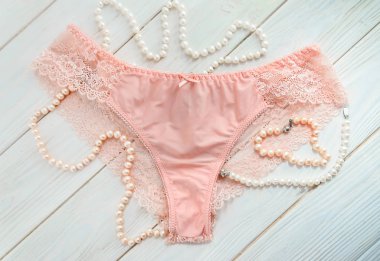 Delicate pink lace panties and pearl beads  clipart