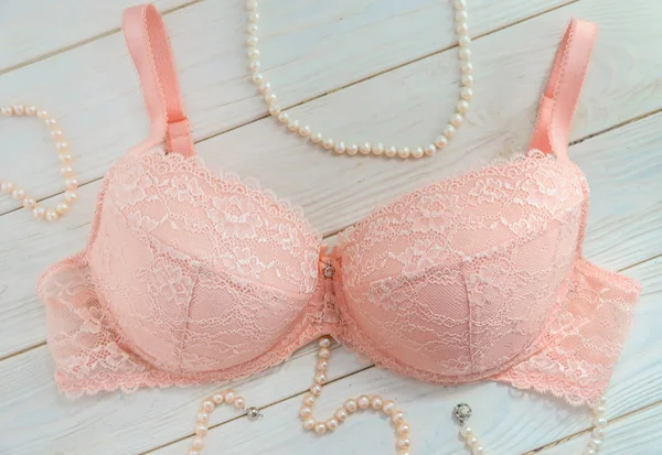 Delicate pink lace bra and pearl beads — Stock Photo, Image