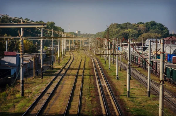 View of the old dusty railway with freight cars and power lines — Stock Photo, Image