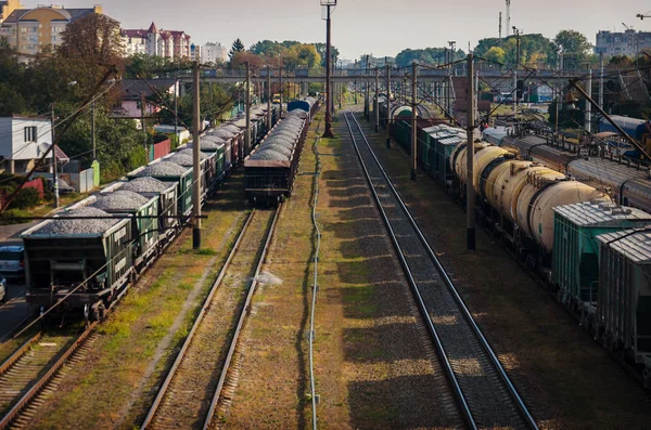 View of the old dusty railway with freight cars and power lines — Stock Photo, Image