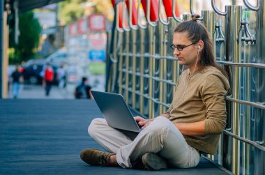 Şehirde bilgisayar başında çalışan çekici stil düşkünü bir hippi.
