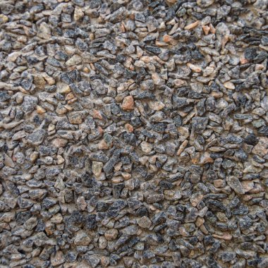 Küçük yol taşı arka plan, koyu çakıl taşı taş yapı.