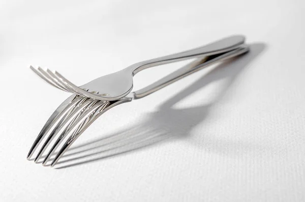 Two metal shiny forks on a light background. — Stock Photo, Image