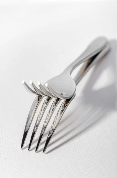 Two metal shiny forks on a light background. — Stock Photo, Image