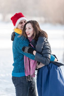 Mutlu çifti eğleniyor buz pateni pisti açık havada.