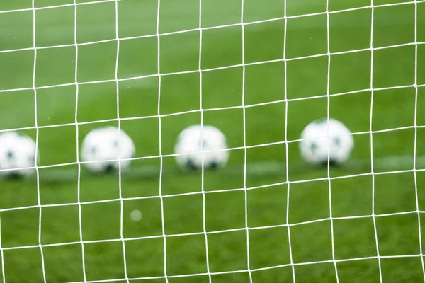 Soccer net and soccer ball on green grass — Stock Photo, Image