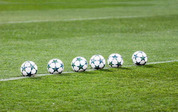 Soccer balls on green grass. — Stock Photo, Image