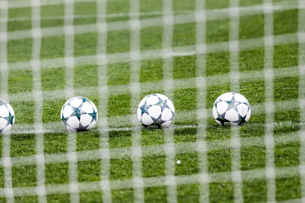 Soccer balls on green grass. — Stock Photo, Image