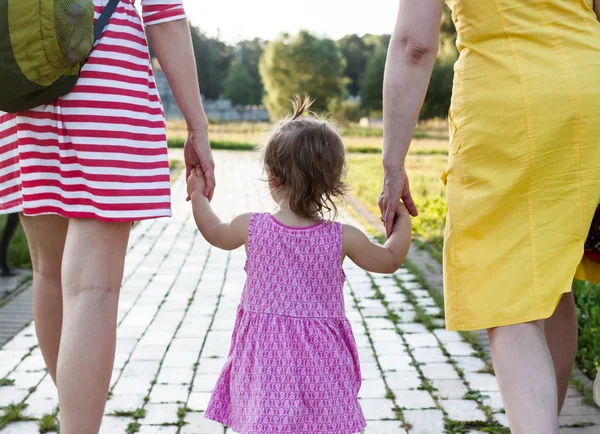 Granddaughter holding hands of mother and grandmother — Stock Photo, Image