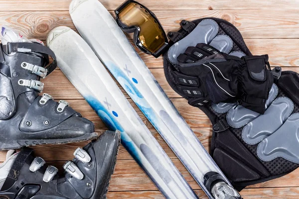 Vue aérienne des accessoires de ski placés sur une table en bois rustique . — Photo