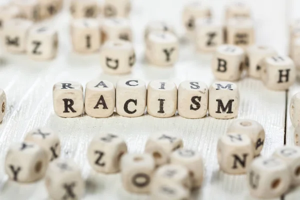 Racism word written on wood block. — Stock Photo, Image