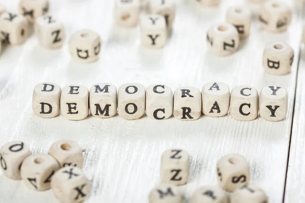 Democracy word written on wood block. — Stock Photo, Image