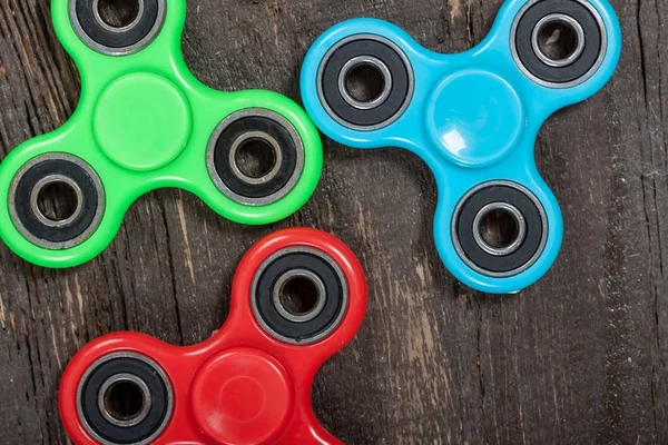 Group of spinners on wooden table — Stock Photo, Image