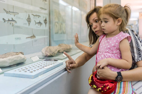 Mother and daughter in museum.