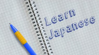 Japonca öğren. Defter sayfasına elle yazılmış metin ve canlandırma.