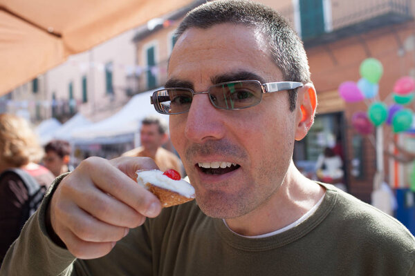 Man Eating Sicilian Cannolo