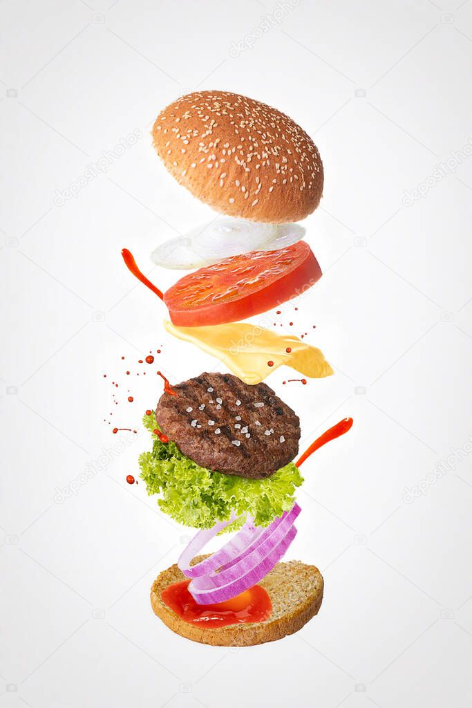 Hamburger with floating layers on light background