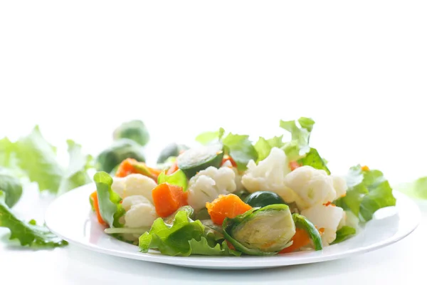 Salad of lettuce, cauliflower and Brussels sprouts with a pumpkin — Stock Photo, Image