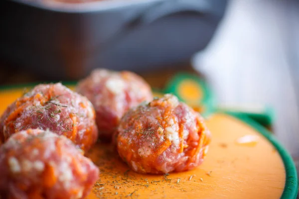 Raw meatballs tangled meat with carrots — Stock Photo, Image