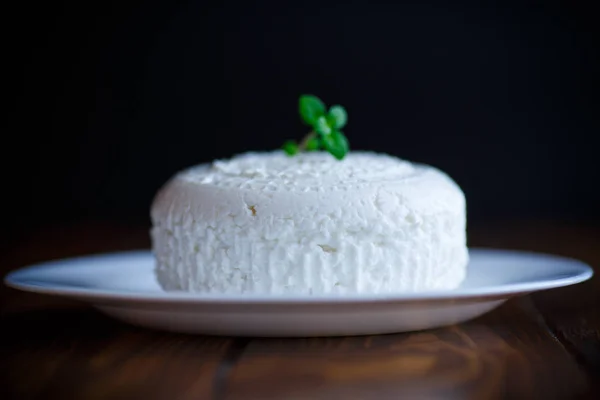 Cottage cheese in a white plate — Stock Photo, Image