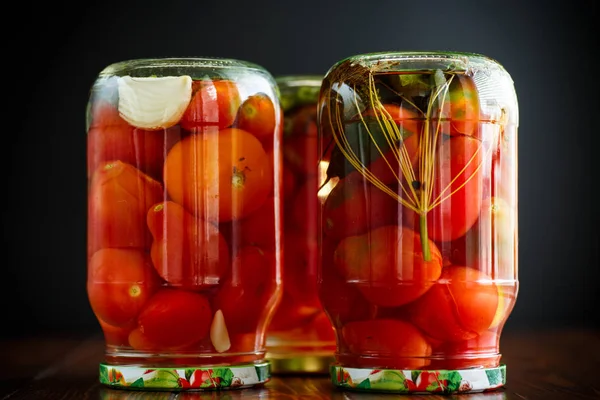 Home preservation. Canned in a glass jar ripe tomatoes. — Stock Photo, Image