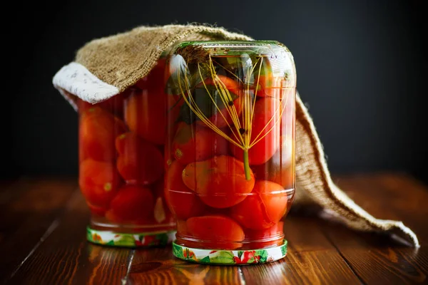 Home preservation. Canned in a glass jar ripe tomatoes. — Stock Photo, Image