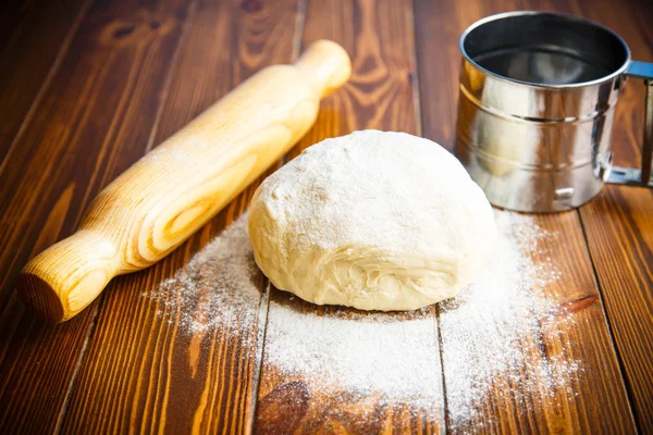 Färsk rå deg med en brödkavel — Stockfoto