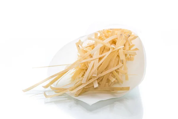 Homemade egg noodles in a paper package — Stock Photo, Image