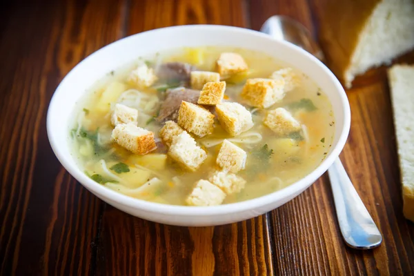 Hot chicken soup with homemade noodles and croutons — Stock Photo, Image