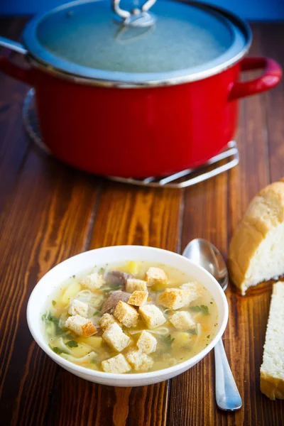 Hot chicken soup with homemade noodles and croutons — Stock Photo, Image