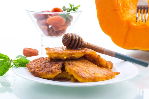 Tasty fried sweet pumpkin pancakes with honey — Stock Photo, Image