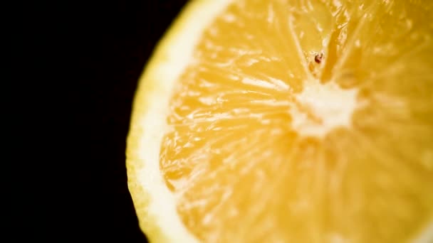 Lemon isolated on a black background. Fresh and Ripe halved lemon rotating — Stock Video