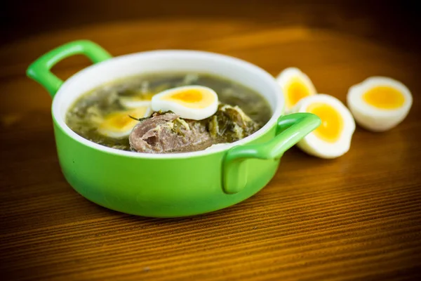 Fresh spring organic soup with green sorrel and egg in a plate on a wooden table — Stock Image Fresh Spring Organic Soup Green Sorrel Egg Plate Wooden Table Stock Image