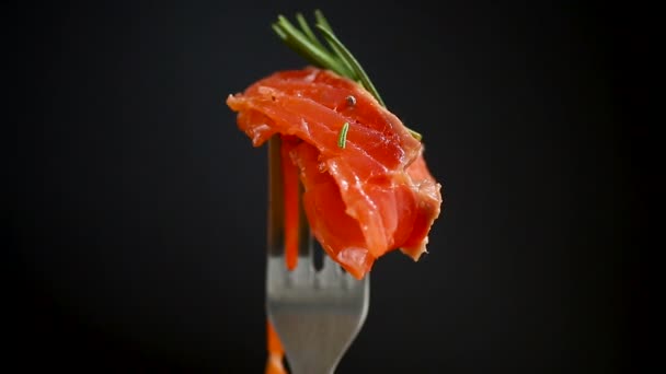 Slice of salty red fish on a fork, wooden background — Stock Footage Slice Salty Red Fish Fork Wooden Background Video Clip
