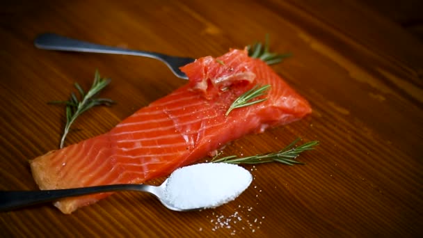 Slice of salty red fish on a fork, wooden background — Stock Footage Slice Salty Red Fish Fork Wooden Background Video Clip