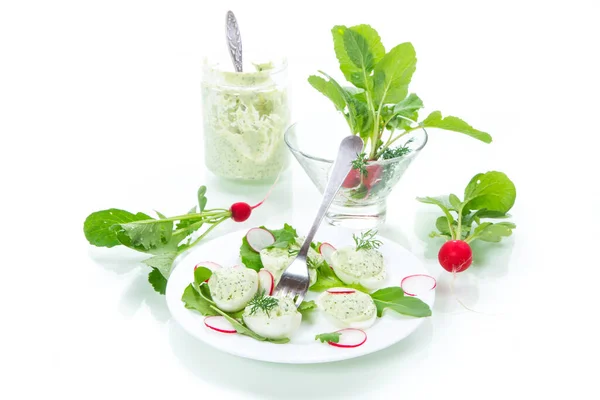 Boiled stuffed eggs with green cheese filling with arugula leaves and radish — Stock Photo, Image