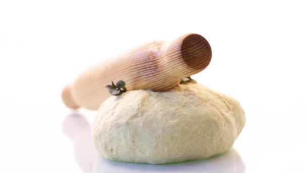 Piece of raw yeast dough with a sprig of mint on a white background — Stock Video