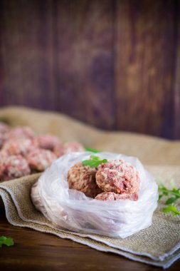 Sığır etinden donmuş çiğ köfte ve havuçlu domuz eti ve selofan torbada pilav.