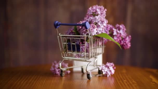 Bouquet Spring Blossoming Lilacs Shopping Cart Wooden Background — Stock Video