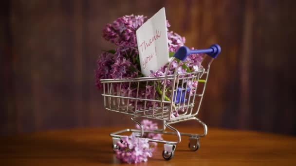 Bouquet Spring Blossoming Lilacs Shopping Cart Wooden Background — Stock Video