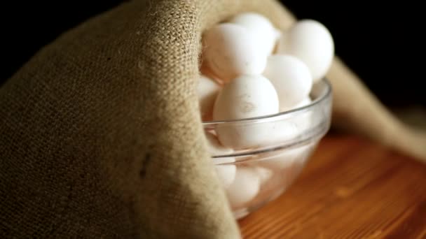 Organic homemade fresh eggs in a glass bowl under burlap — Stock Video