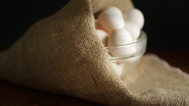 Organic homemade fresh eggs in a glass bowl under burlap — Stock Video