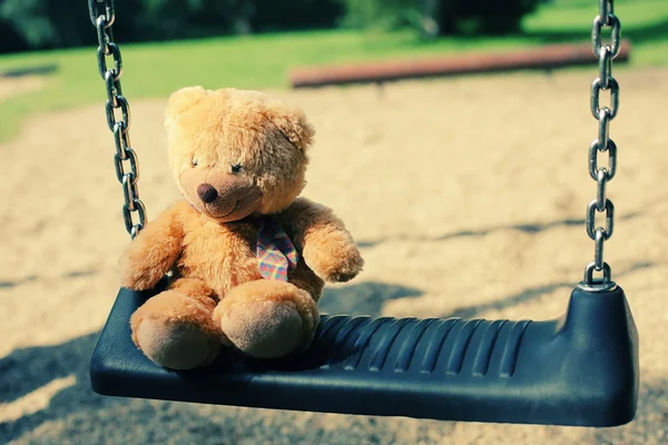 Teddy bear on swing — Stock Photo, Image