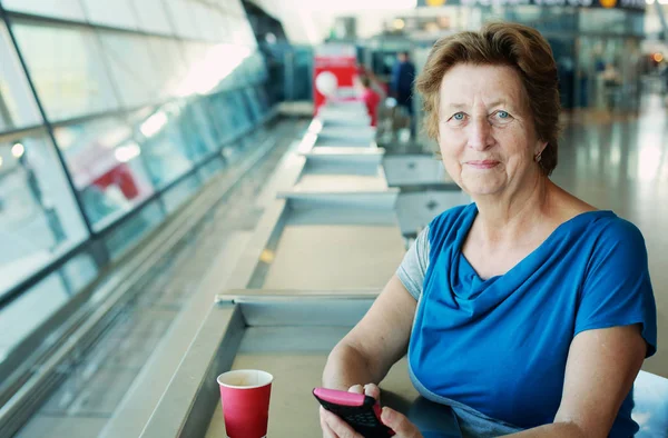 Frau sitzt im Flughafen — Stockfoto