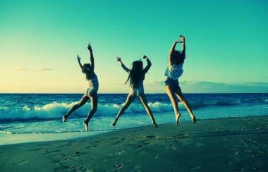 Üç kız sahilde atlama  